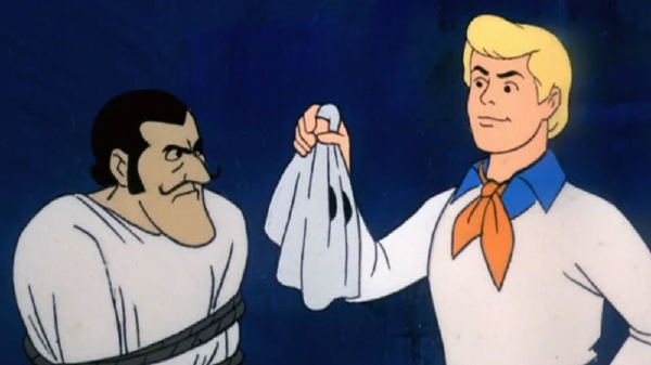 A still from the Scooby Doo cartoon in which the mask of the culprit is removed and their identity is revealed